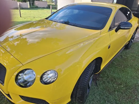 Yellow Bentley Continental front three-quarter view